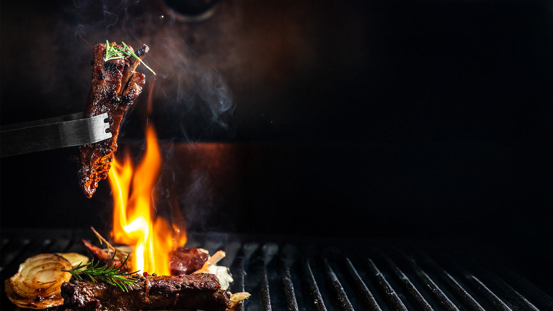 Grilled meat with flames on restaurant grill - GRILL'D Restaurant